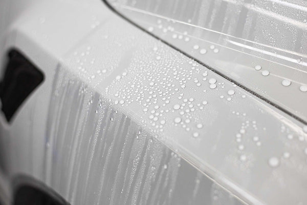 Water droplets on a white car.
