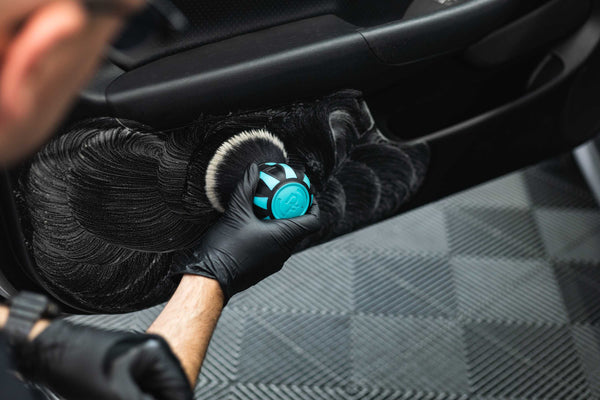 Person cleaning car door interior with a Detail Factory Curveball riptide.