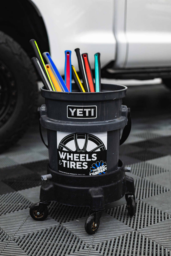 Grey Yeti bucket filled with all color options of Detail Factory Fender Well brush.