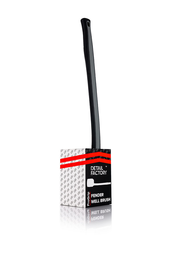 A red Detail Factory Fender Well Brush in its container on a white background.
