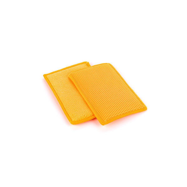Two orange Jersey Bug Scrubbers on a white background.