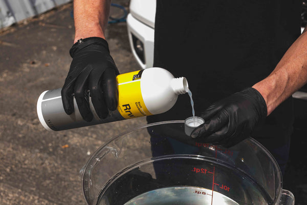 Koch-Chemie Rapid Rinseless Wash poured into the cap and put into a bucket.