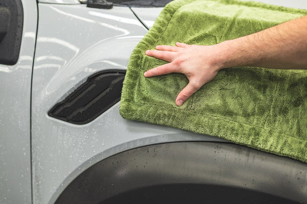 Person cleaning a car with a green m22