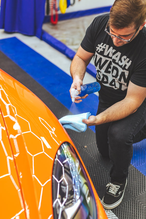 Person cleaning a car with Opticoat Hyper Seal