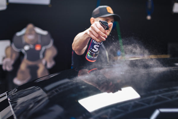 Person spraying P&S Triple S onto the roof of a car.