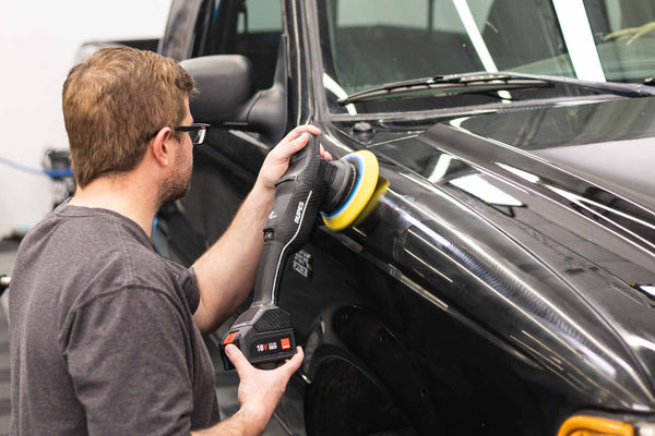 Rupes Da fine yellow polishing pad attached to a polisher polishing a ranger.