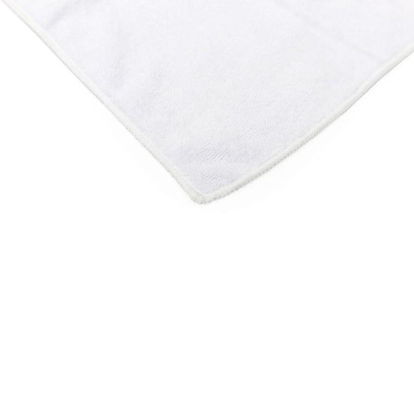 The corner of a white Spa and Workout towel on a white abckground.