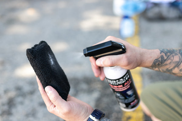 P&S Shine All being sprayed onto a black Terry Sponge.
