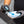 A closeup of a person pouring Armour Detail Quartz Coating onto a blue and grey applicator sponge.