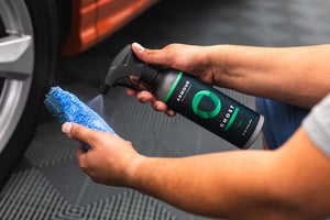A person spraying Armour Detail SUpply Ghost onto a blue applicator.
