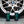 A spray bottle of Armour Wheel Cleaner and a spray bottle of Armour Tire Cleaner in front of a tire.