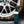 A spray bottle of Armour Tire Cleaner in front of a dirty tire.