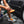 A closeup of a person spraying an orange sponge with Armour Tire+.