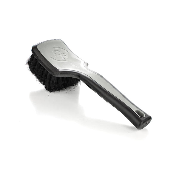 A grey Detail Factory Interior Scrub Brush on a white background.