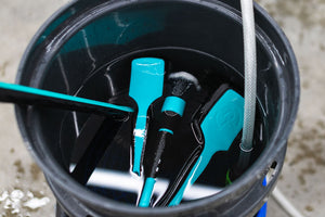 Detail Factory TriGrip Riptide products inside of a bucket filled with water.