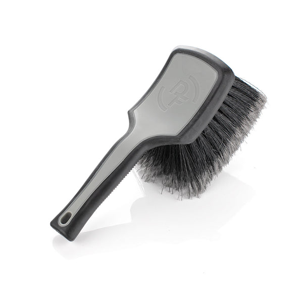 A grey Detail Factory Wheel Face brush on a white background.