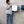 Person holding a white 16x16 dry me a river microfiber towel.