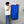 Person holding a navy blue 20x40 dry me a river microfiber towel next to a red car.