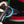 A person using a Rupes Polisher on the back of a black vehicle.