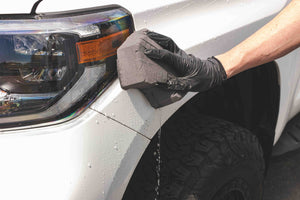Koch-Chemie Rapid Rinseless Wash on a black sponge applied to a white toyota tundra. 