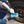 Person cleaning a car's tire with KochChemie Tire Glaze on a blue applicator.