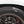 Close-up of a car tire with a gold rim.