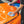 Person cleaning an orange car with Opti-Coat Hyper Seal