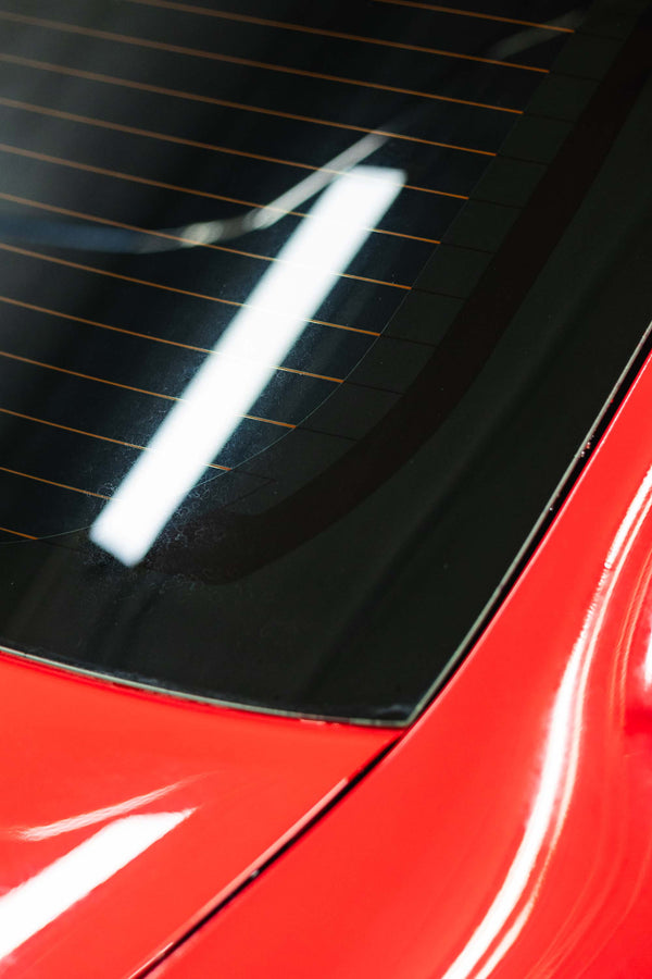 Opti-Coat MDR after on a rear window of a red car.