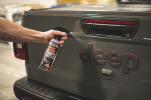 A person spraying the back of a jeep with P and S Paint Gloss.