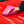 Person cleaning a car hood with a pink FTW microfiber.