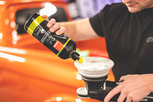 A closeup of someone pouring Rupes Da Fine onto a polish pad.