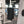 The Rag Company Spa and Workout 16x27 black towel hanging on a metal workout bar.