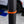 An orange Yellotool Speedclip on a black pole with a car in the background.