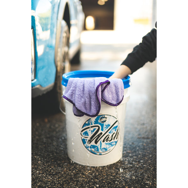 A Minx Royal towel in a white bucket that says wash.
