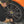 A closeup of a person cleaning a tire with a black towel.