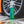 A spray bottle of Opti-Coat Power Clean in front of a wheel.