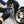 A closeup of a person putting on the Ultra Wheel Mitt with a background of two blurred tires.